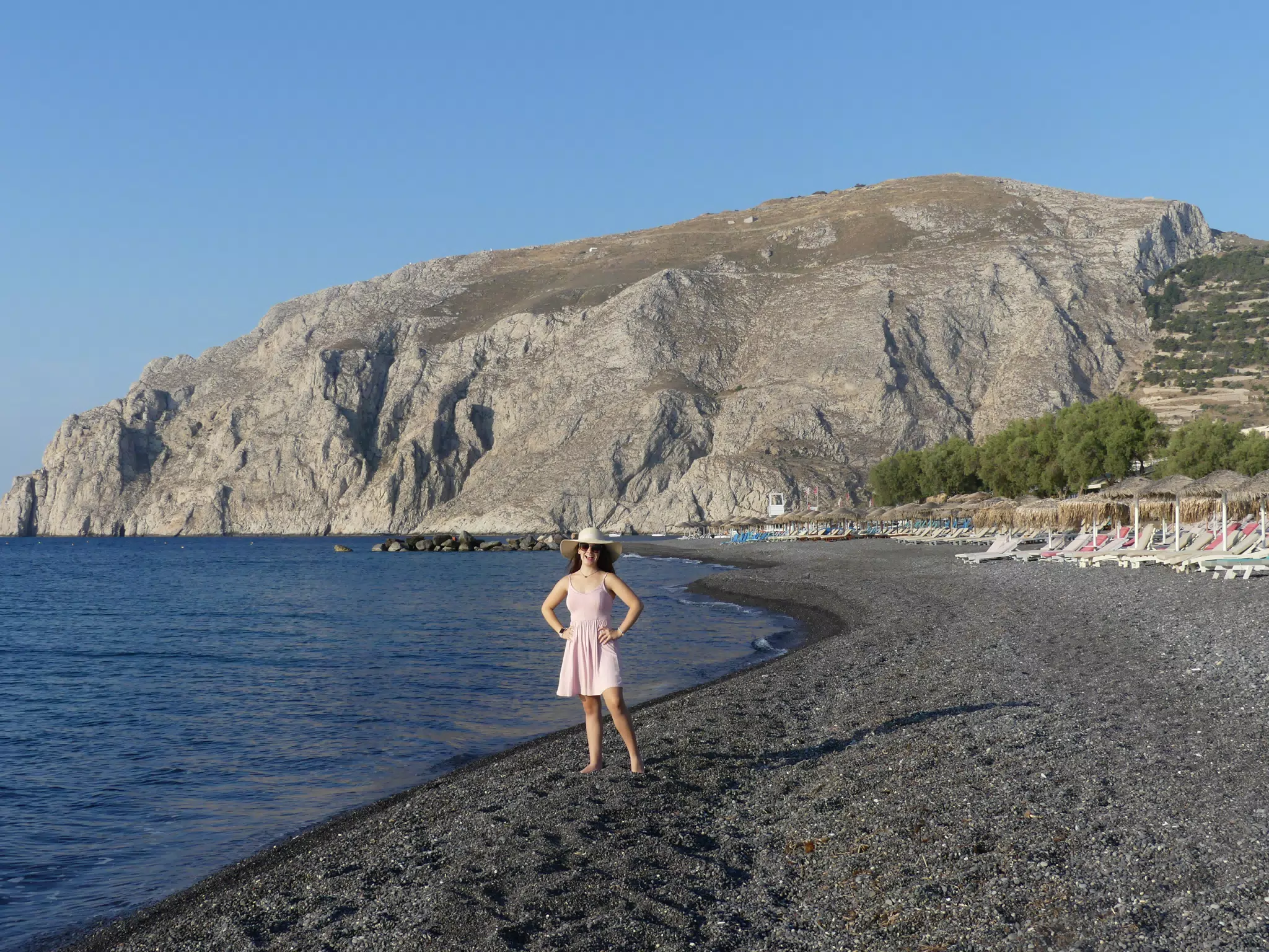 Girl on Beach in Front of Mountain on Santorini