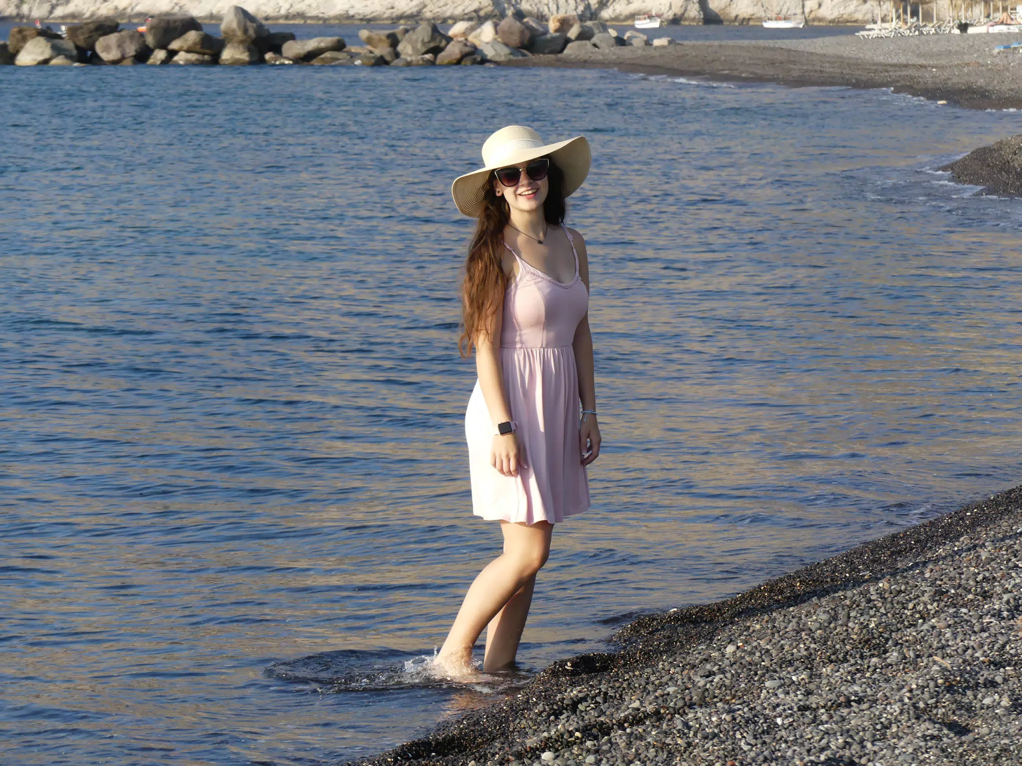 Girl Standing in Water at Santorini Beach