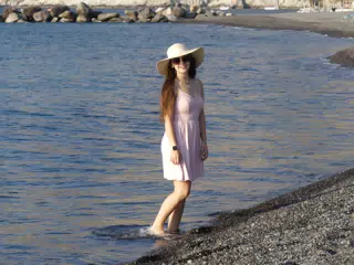 Girl Standing in Water at Santorini Beach