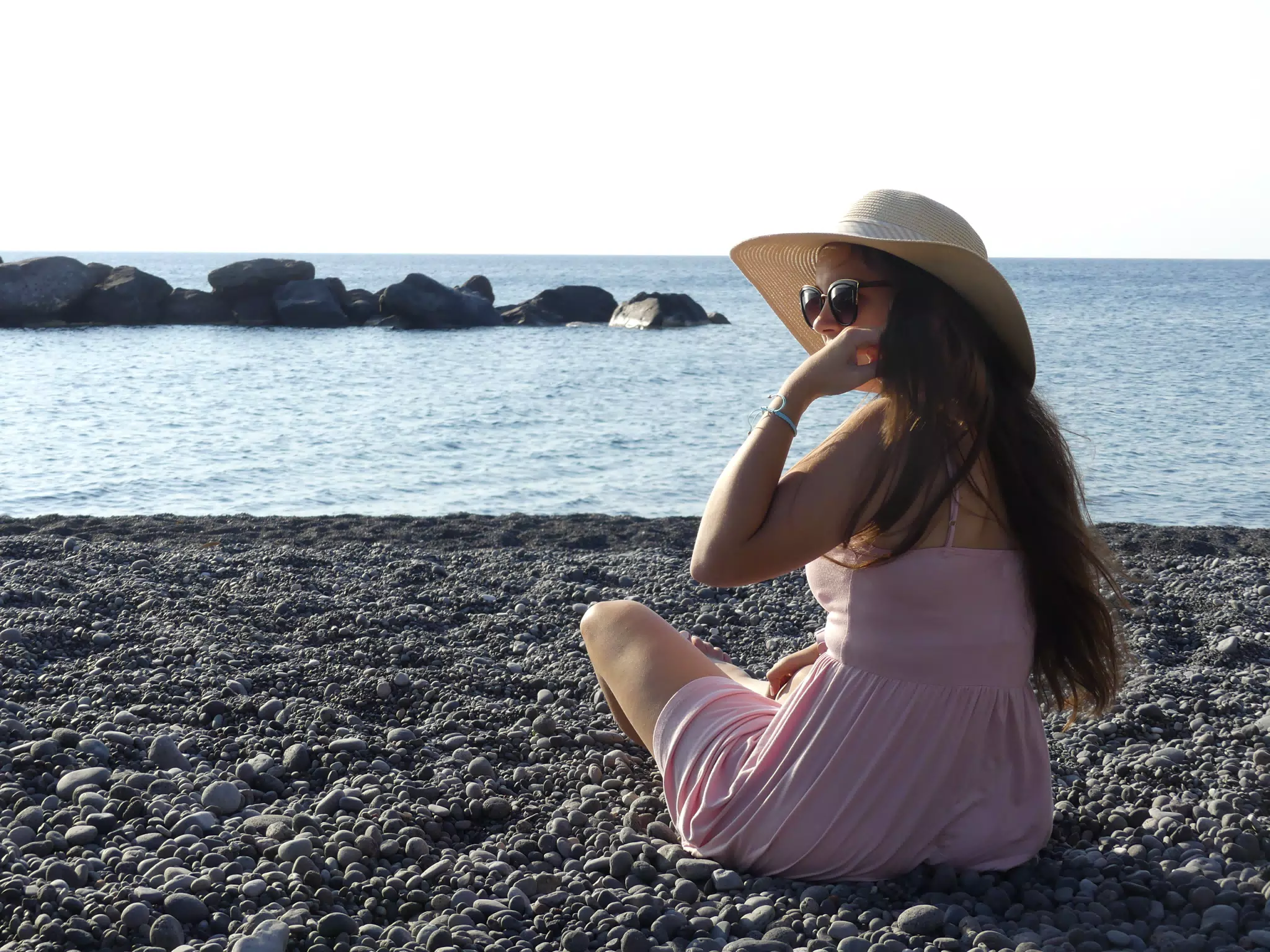 Emily Sitting on Rocky Beach
