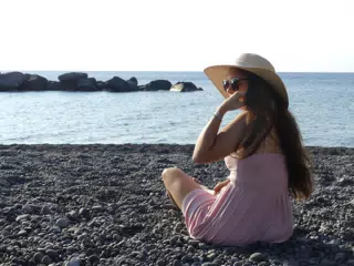 Emily Sitting on Rocky Beach