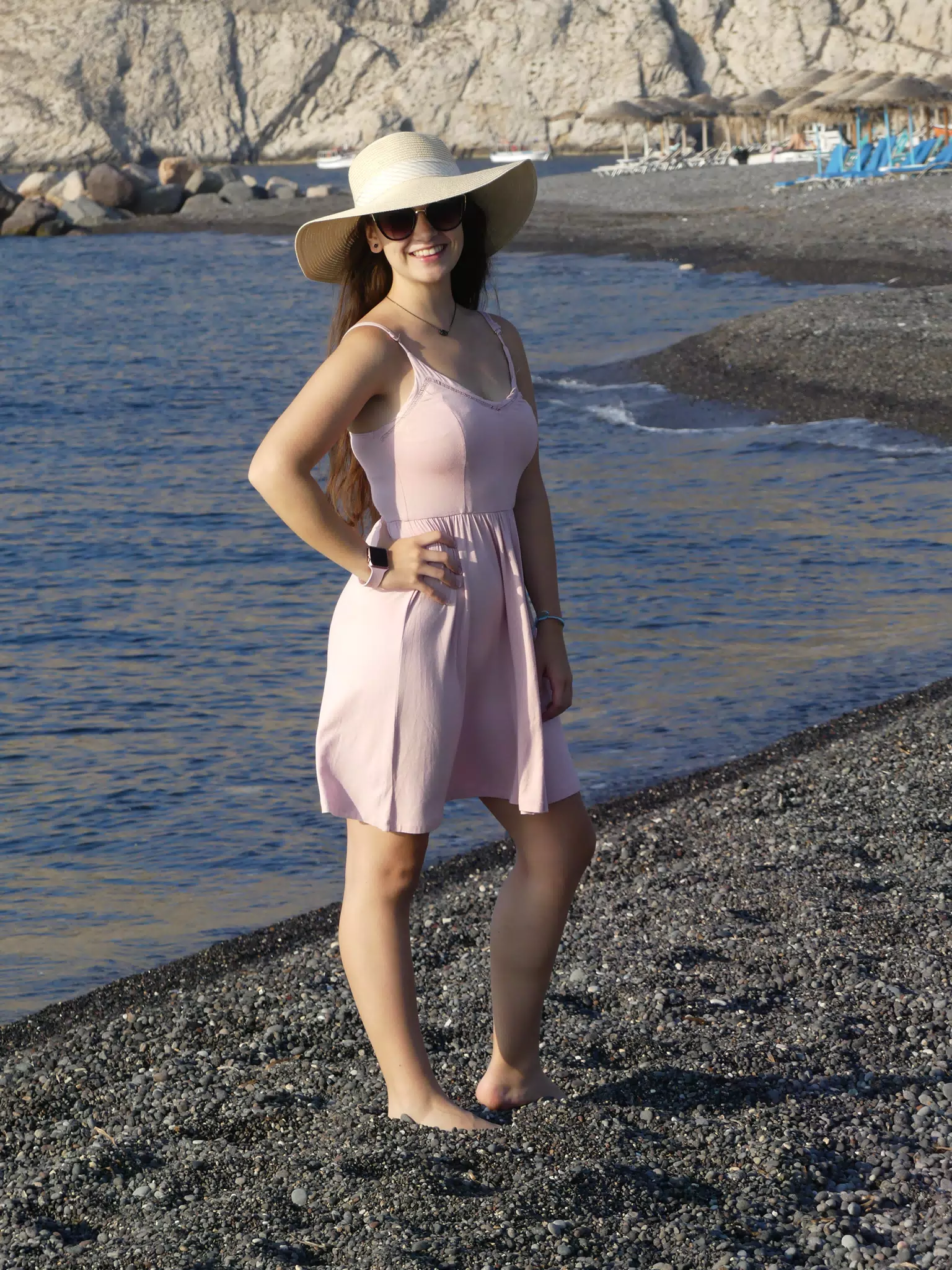 Girl in Hat Posing on Santorini Beach