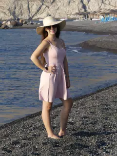 Girl in Hat Posing on Santorini Beach