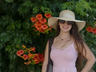 Girl in Hat in Dress with Red Flowers