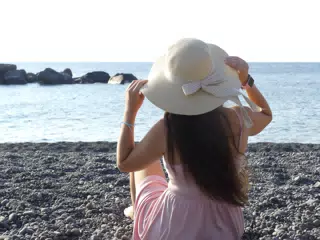 Girl in Hat on Beach Kamari Santorini