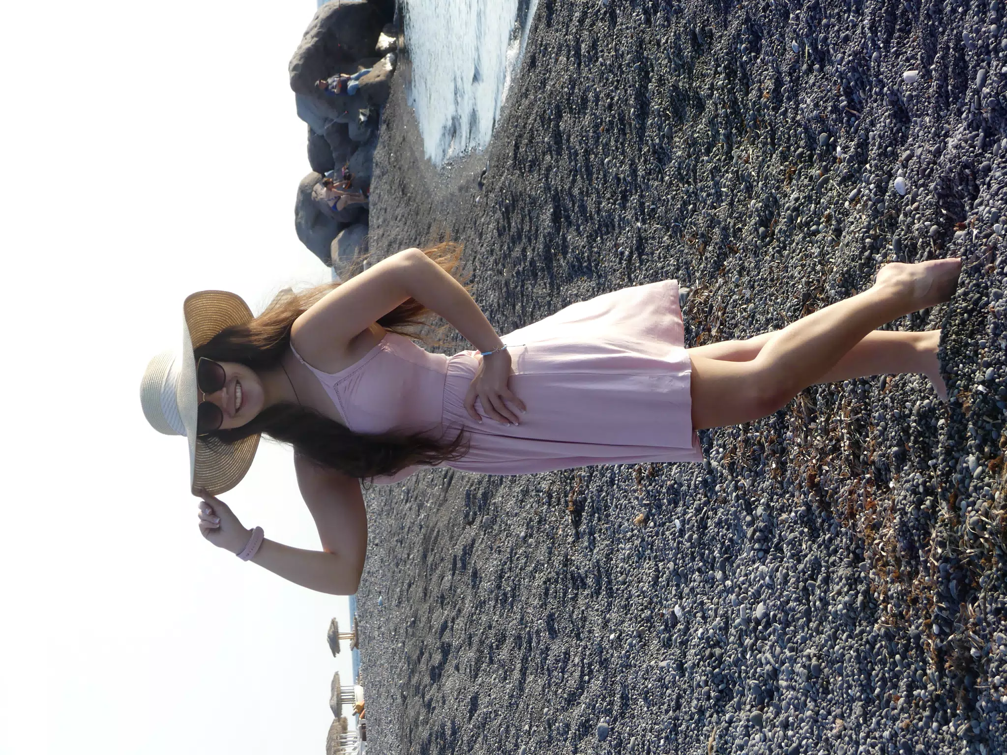 Girl with Hat on Beach on Santorini