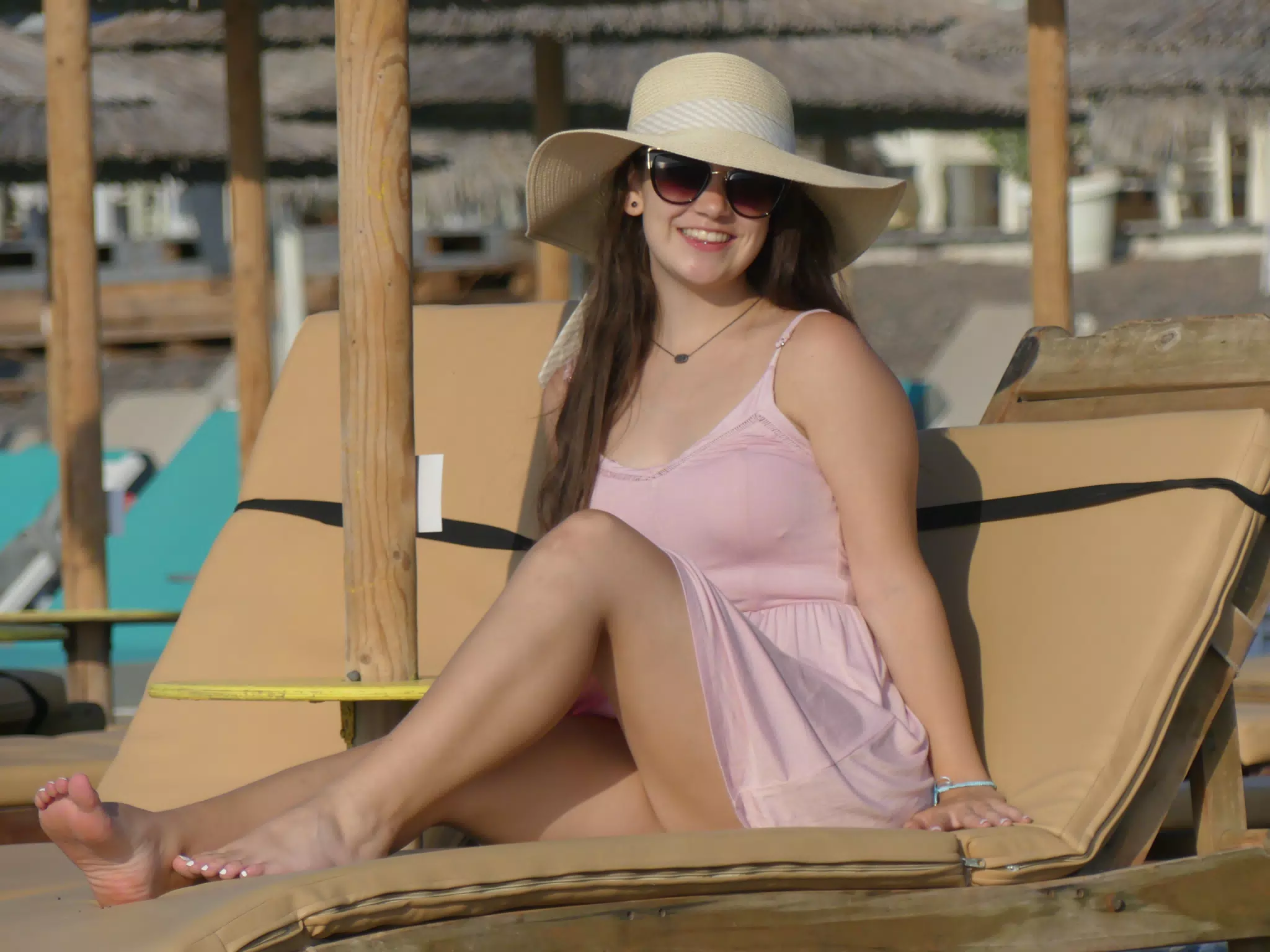Girl in Sundress, Hat, and Sunglasses on Greek Beach
