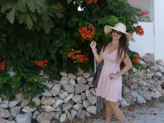 Girl with Flowers and Rocks on Santorini