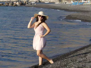 Girl in Pink Dress on Beach on Santorini