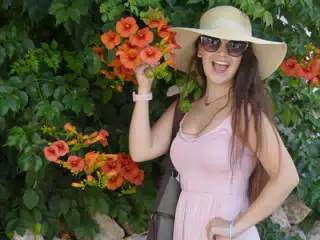 Girl with Hat and Flowers on Santorini