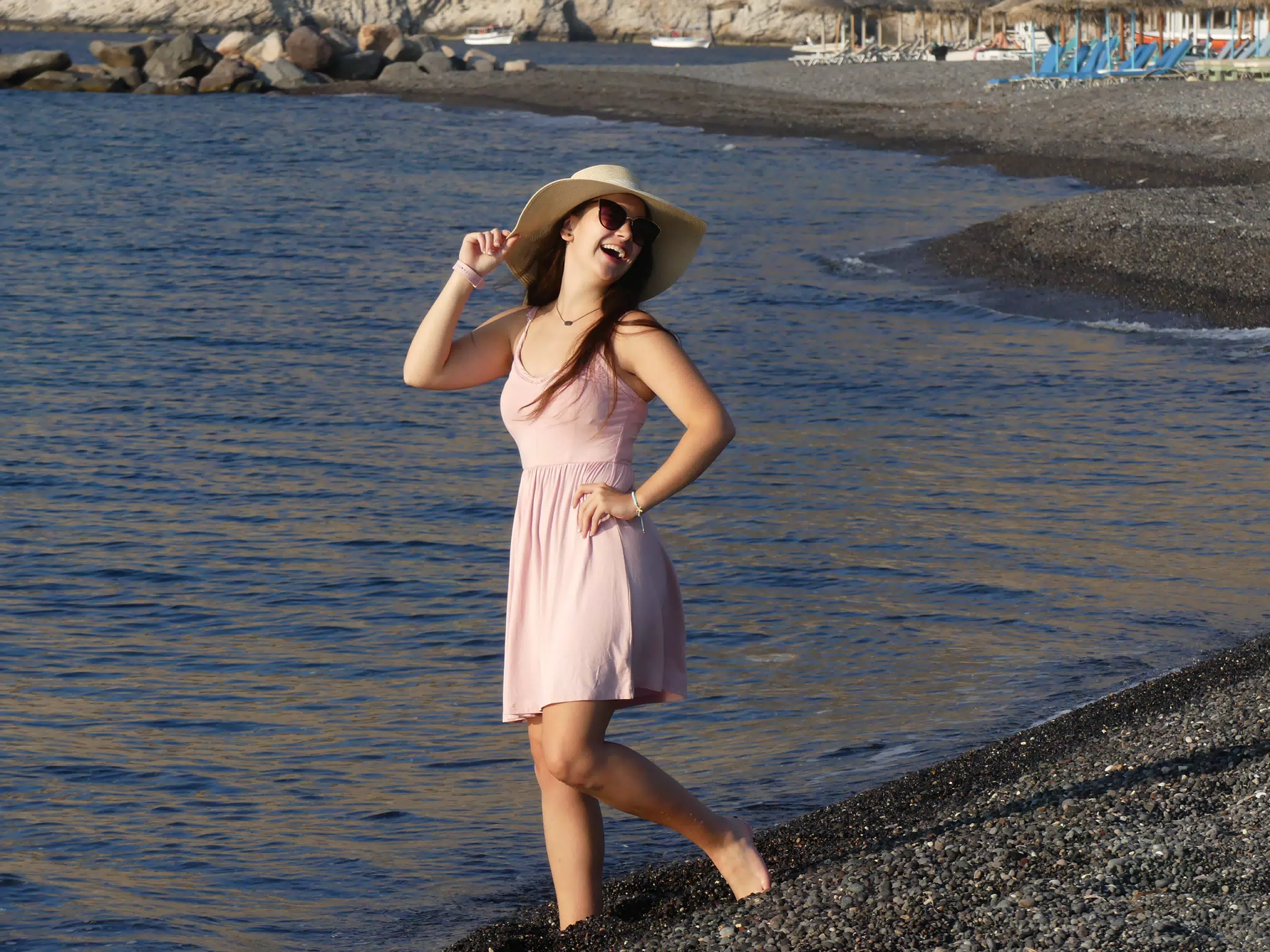 Girl Laughing on Beach of Santorini