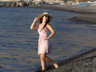Girl Laughing on Beach of Santorini