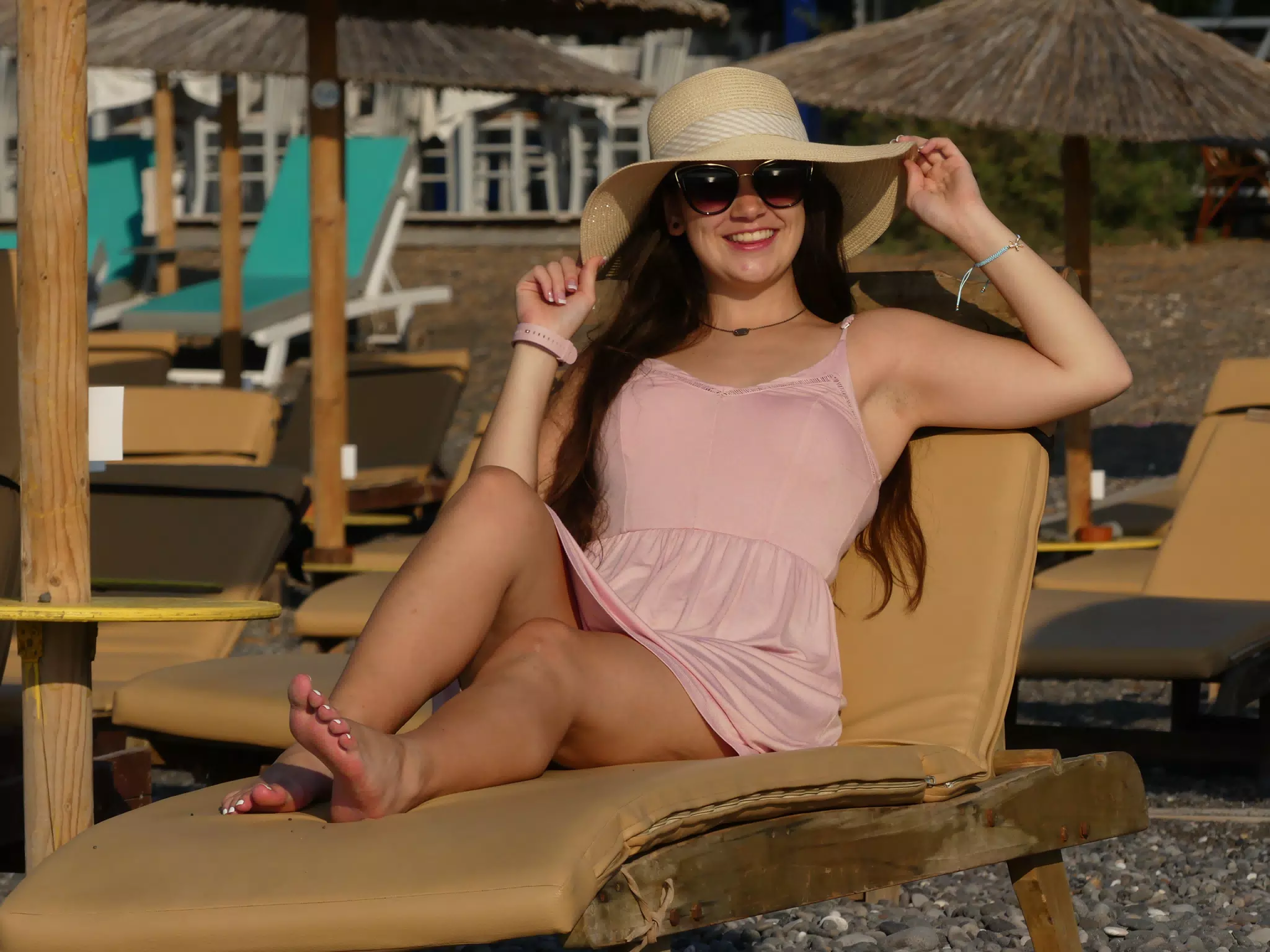 Emily Grice on Beach on Santorini in Hat