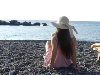 Girl on Beach Looking Out to Sea