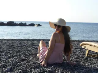 Girl Looking Back on Santorini Beach