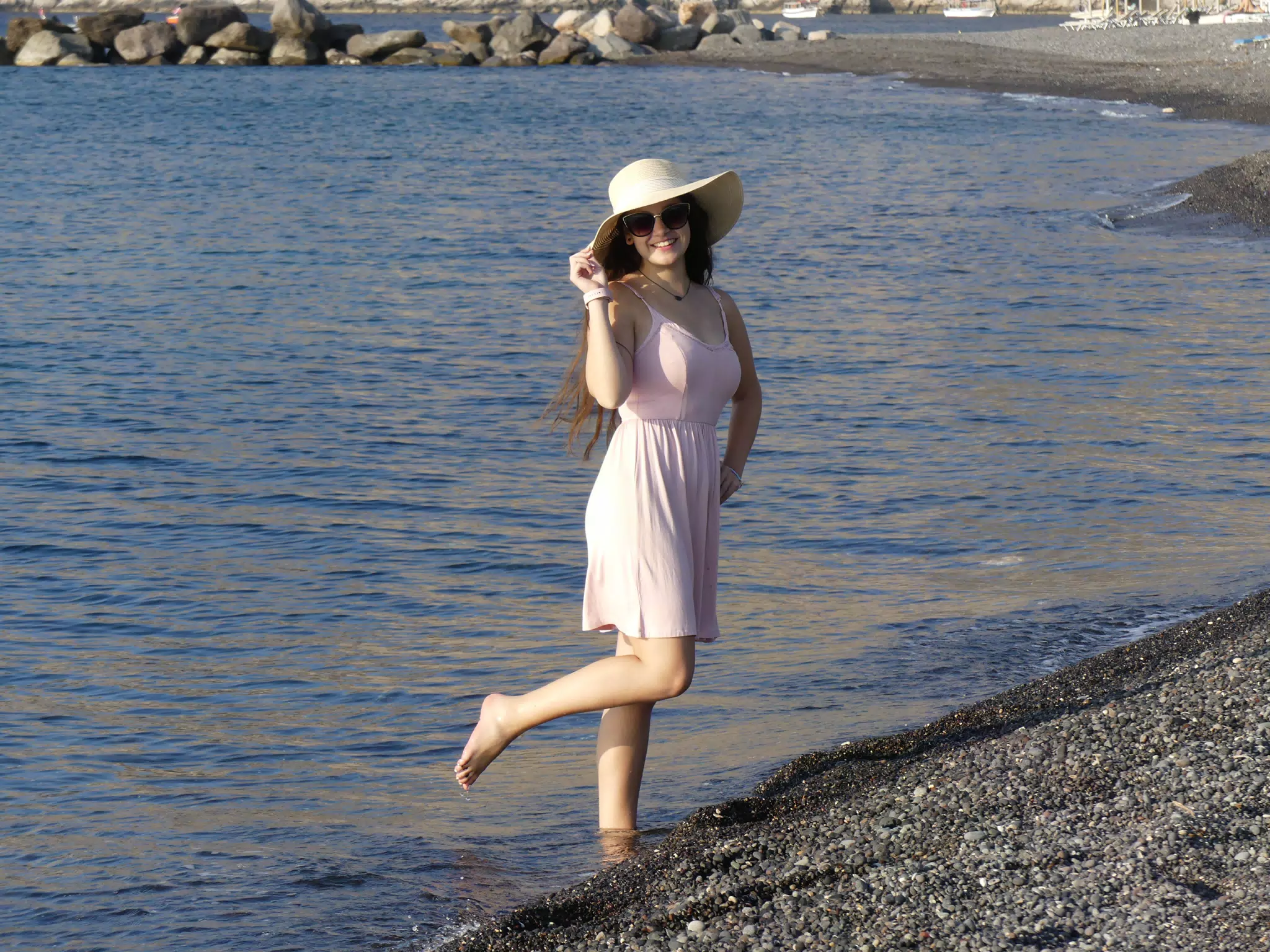 Cute Girl on Santorini Beach in Water
