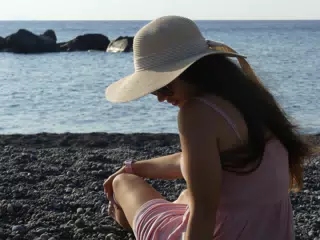 Emily Sitting on Beach at Kamari