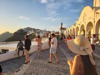 Girl in Hat in Thira at Sunset