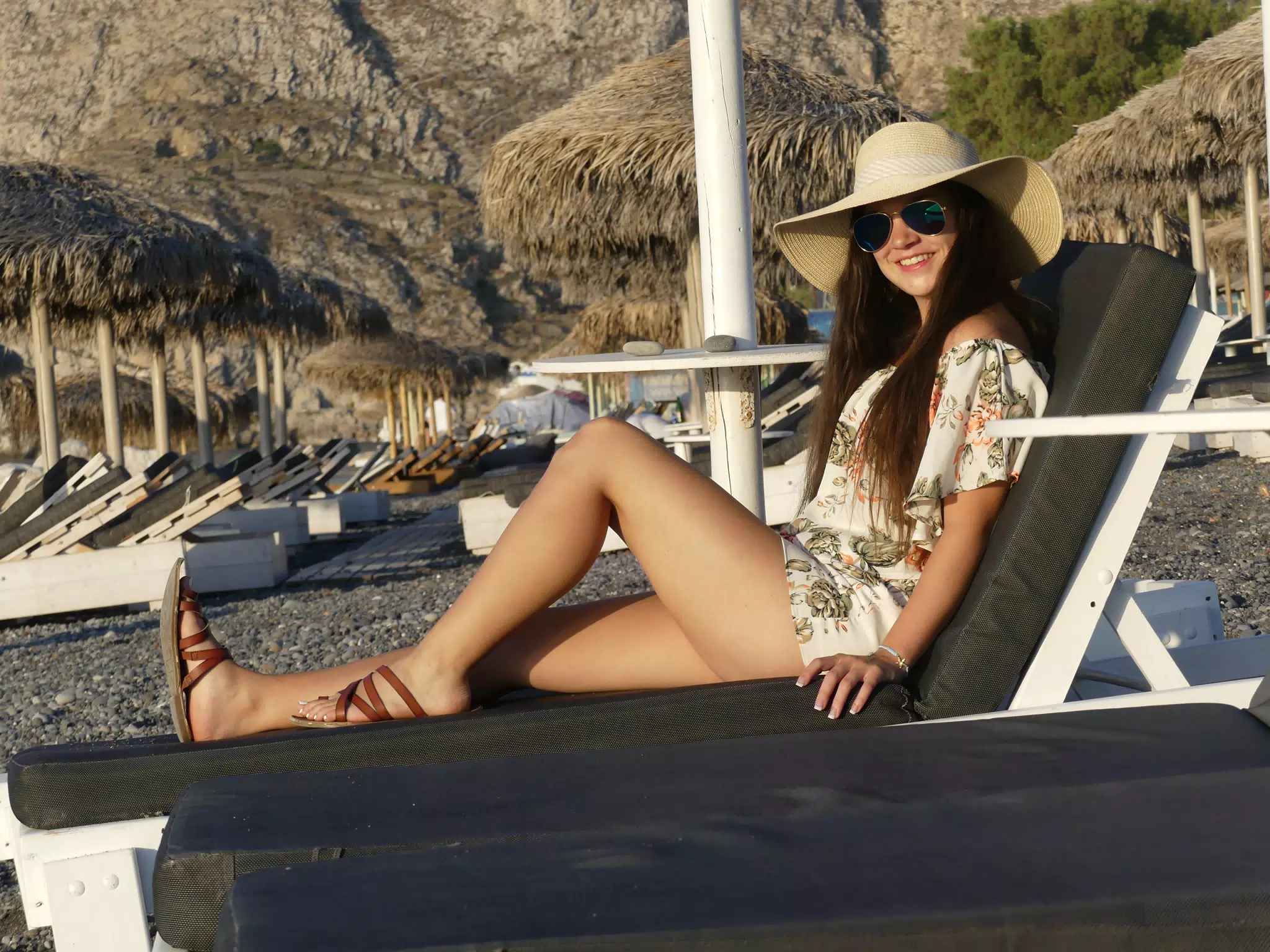 Emily in Hat on Lounge Chair on Santorini