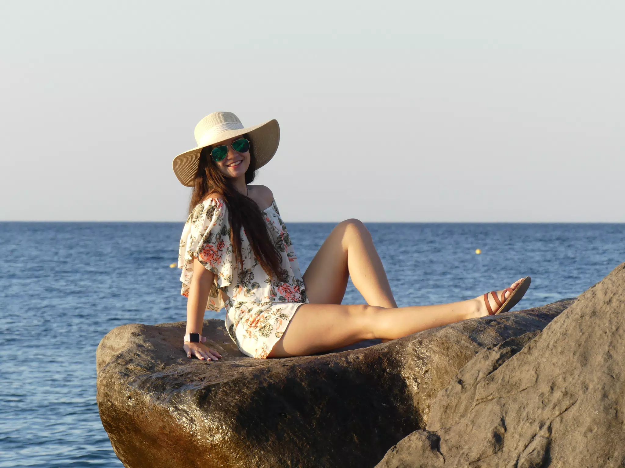 Girl in Hat and Sunglasses at Sunrise on the Beach at Kamari, Santorini