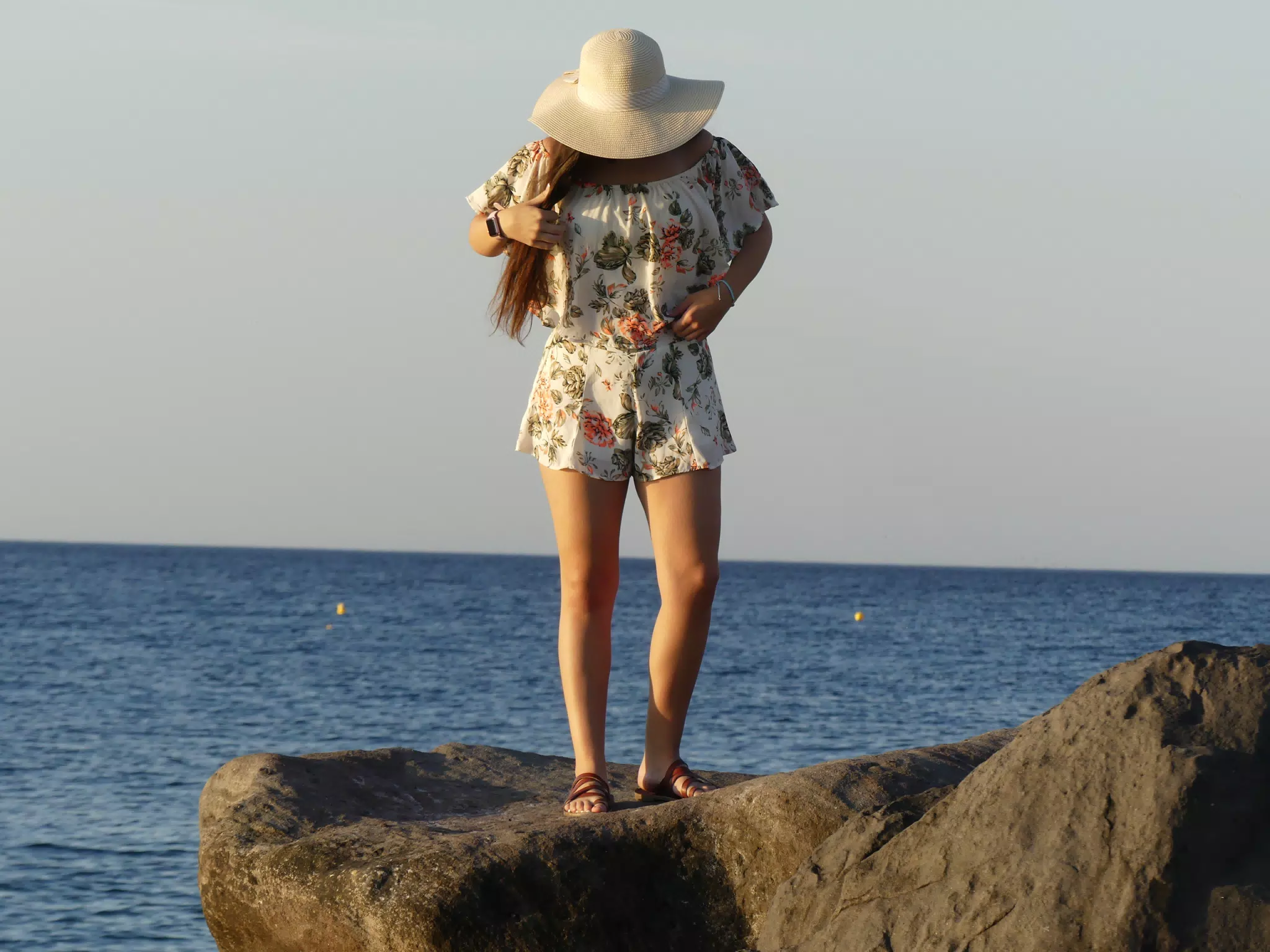 Girl on Rocks by Sea on Santorini