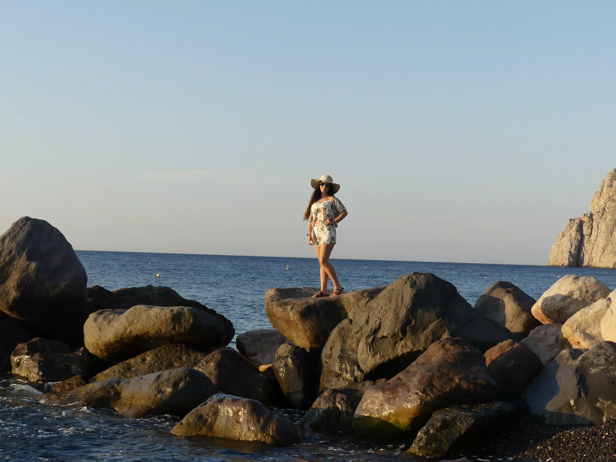 Emily Modeling on the Kamari Beach Rocks on Santorini Island, Greece