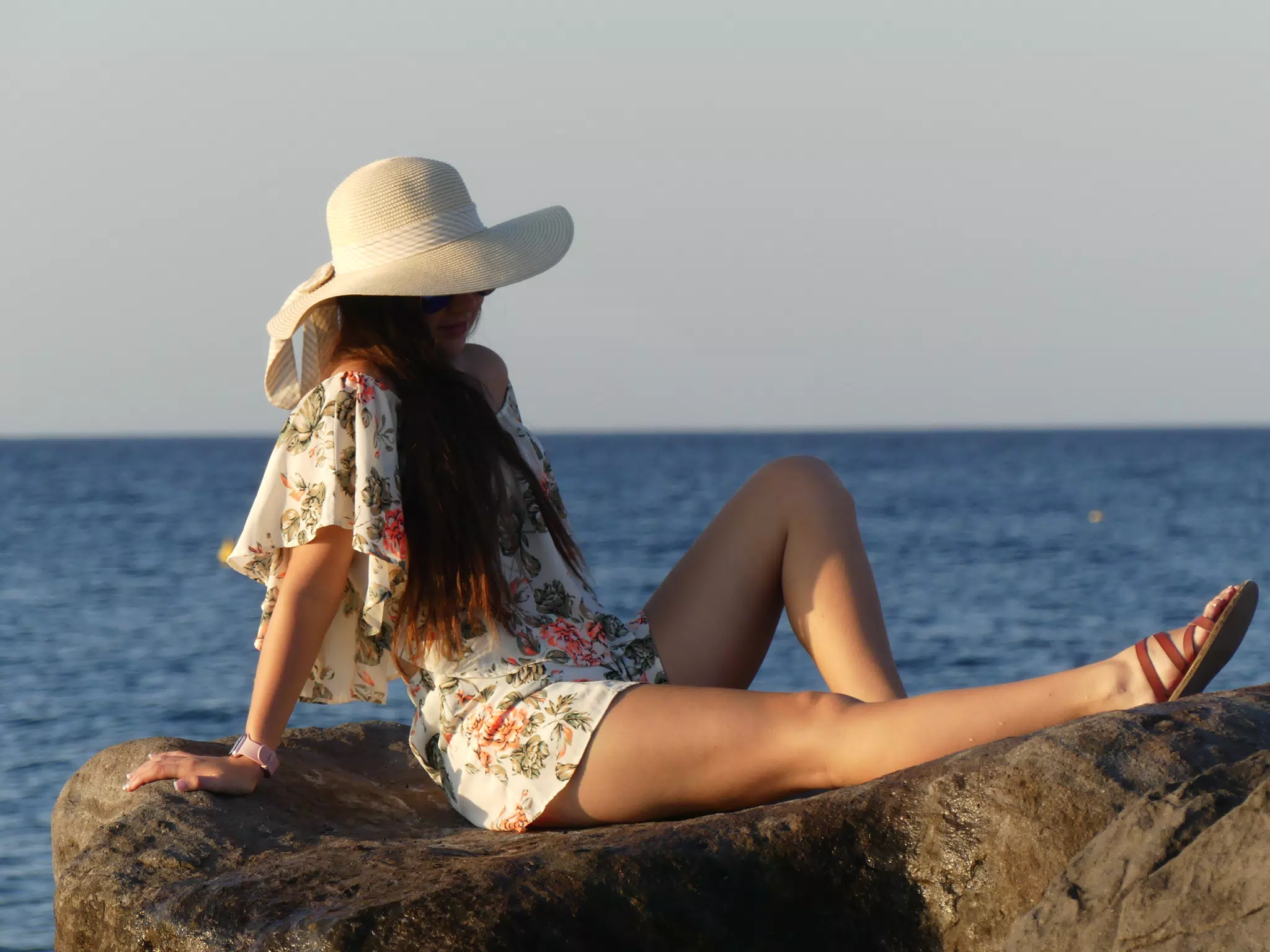 Girl in Hat on Rocks on Santorini