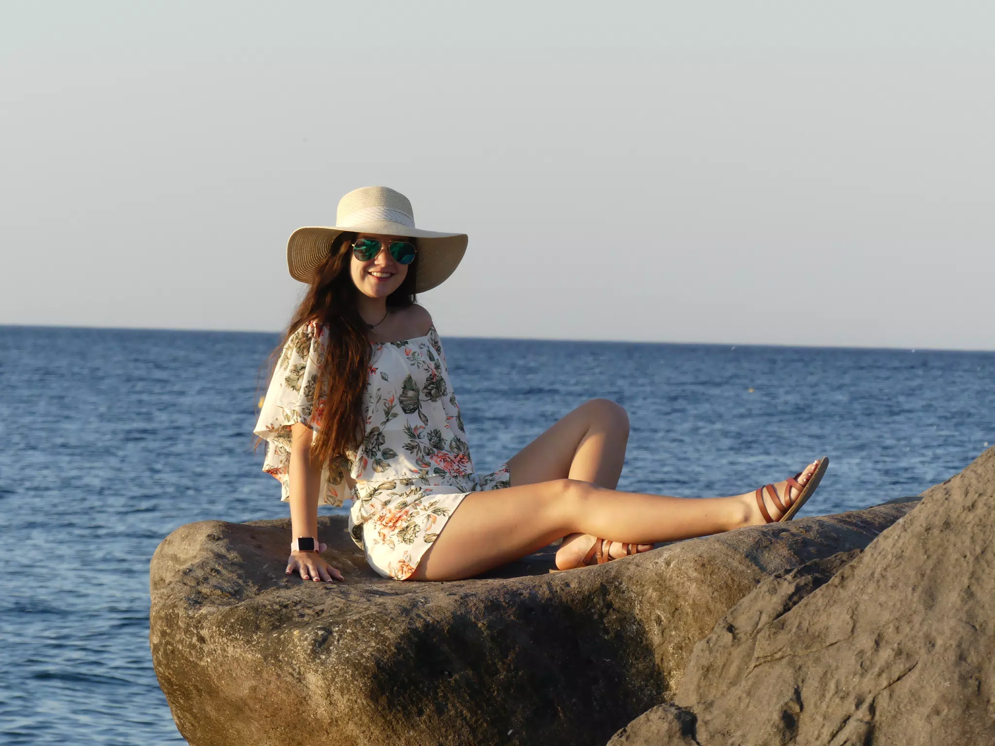 Emily Laying on the Rocks on Santorini Beach in the Sunrise