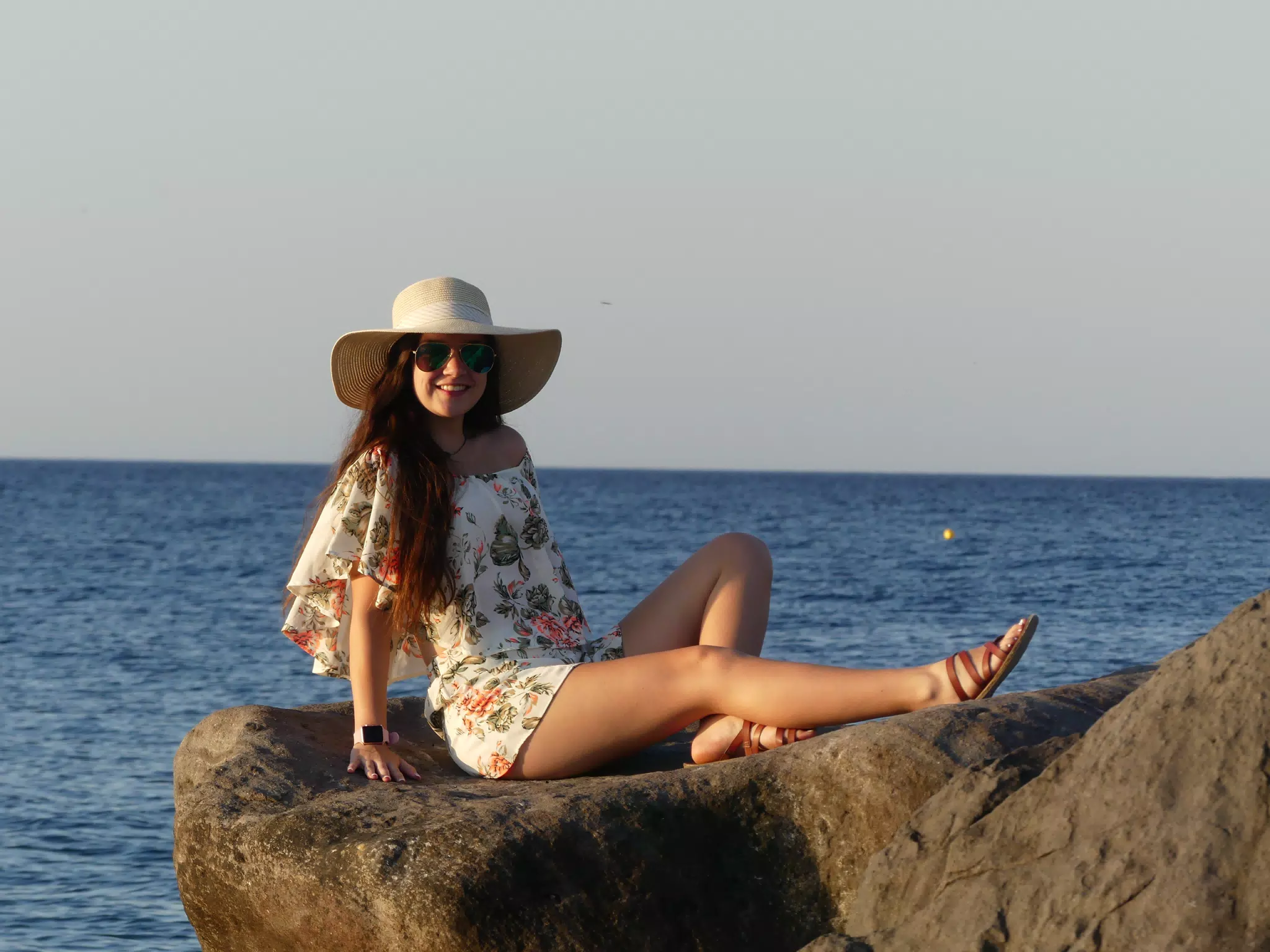 Emily Laying on the Rocks on the Beach on Santorini in the Sunrise