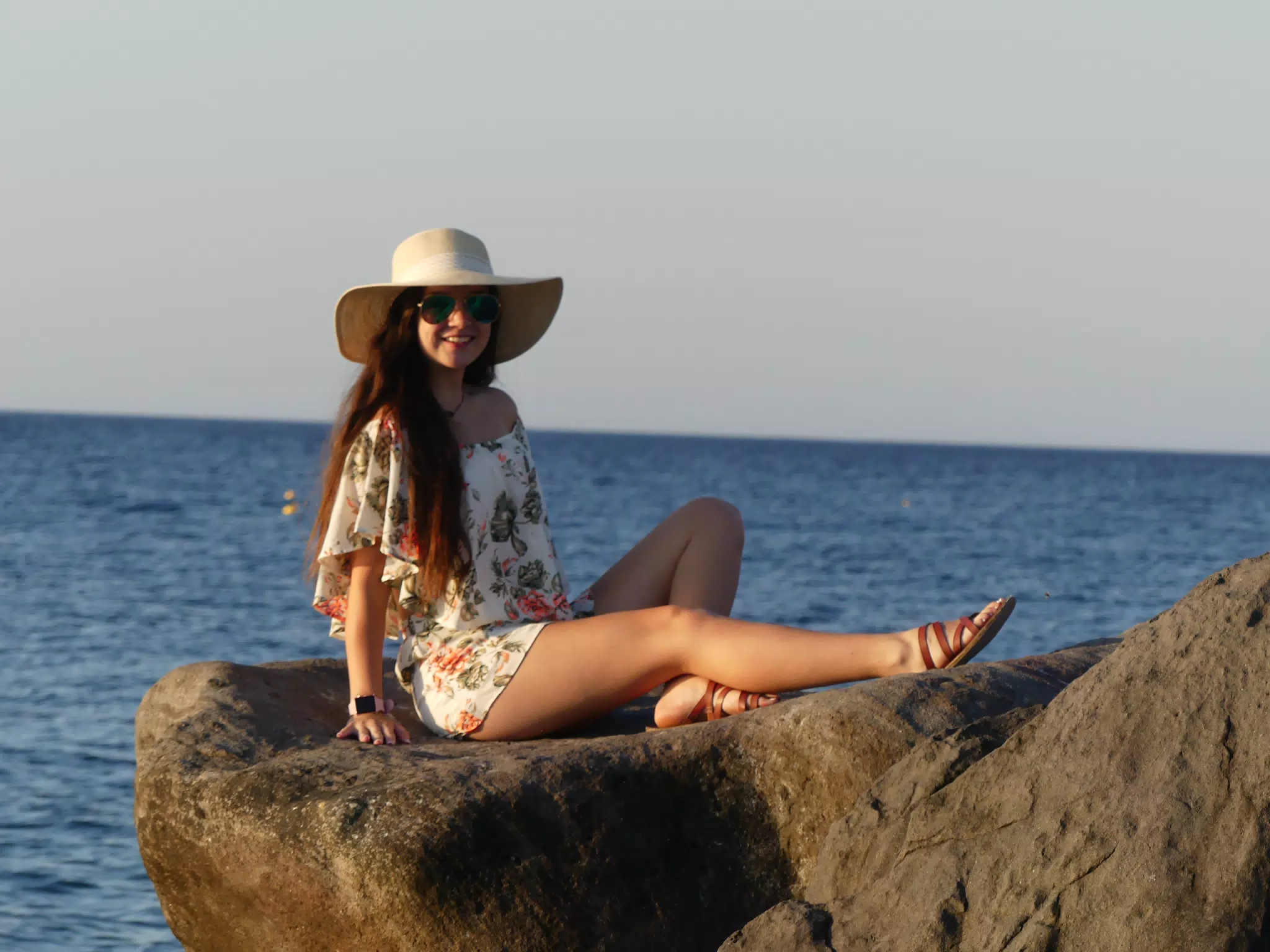 Emily Lounging on the Rocks on Santorini in the Sunrise