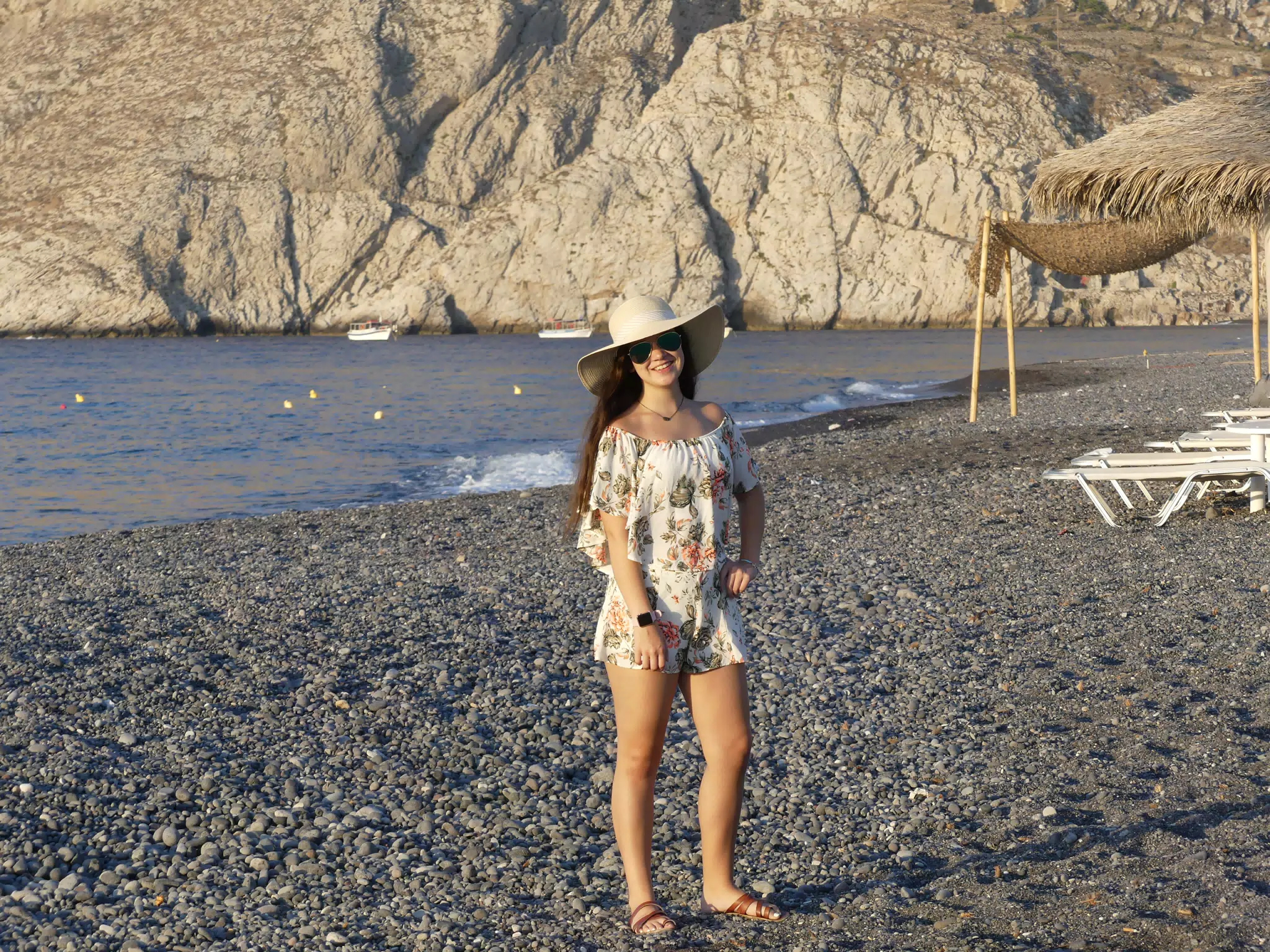 Teen Girl in Hat on Kamari Beach, Santorini Island, Greece