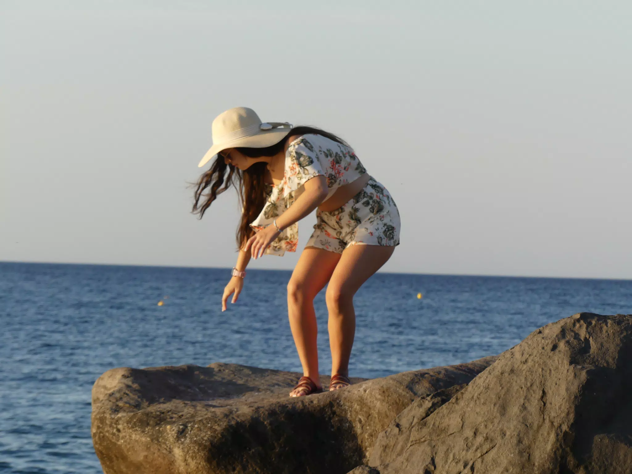 Emily Climbing on the Rocks on Santorini