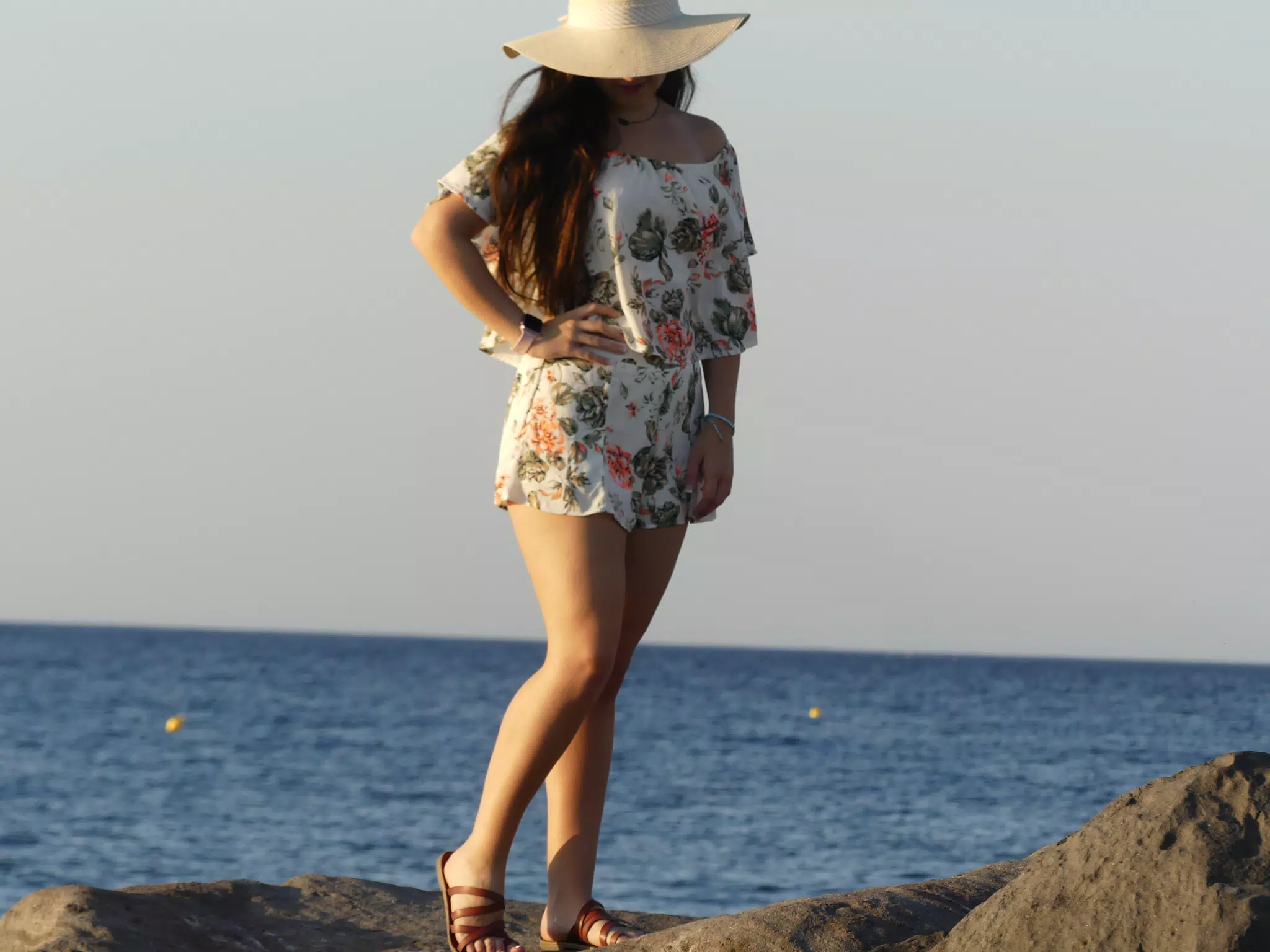 Girl on Rocks on Beach on Santorini