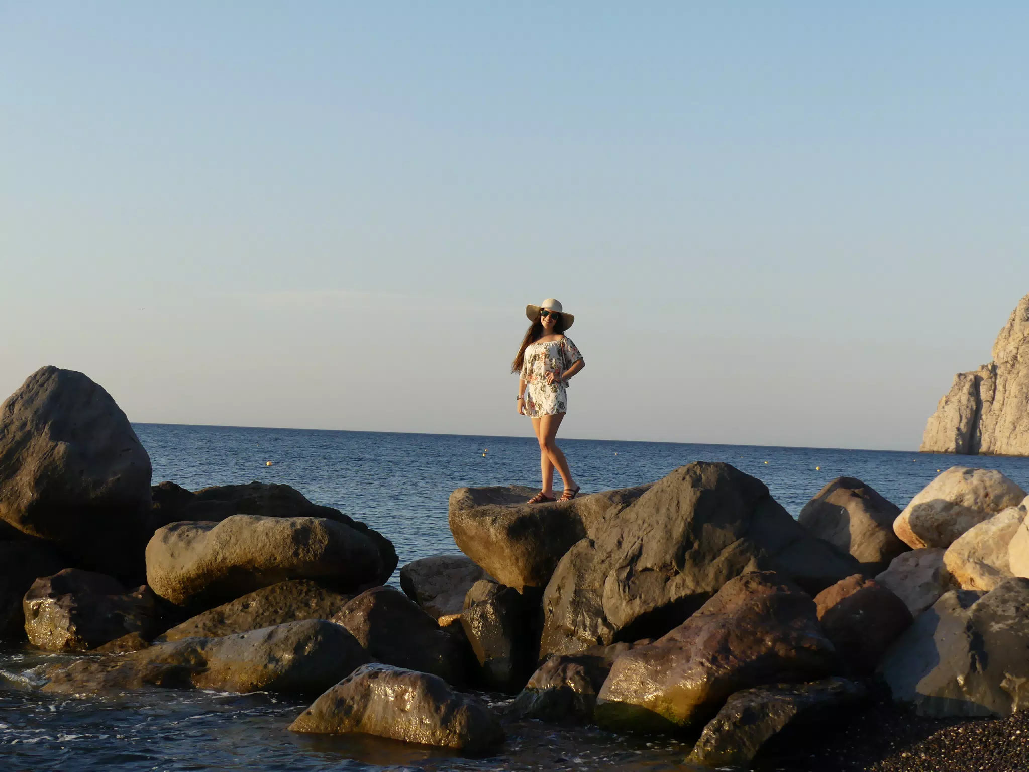 Emily Posing on the Rocks on Kamari Beach, Santorini