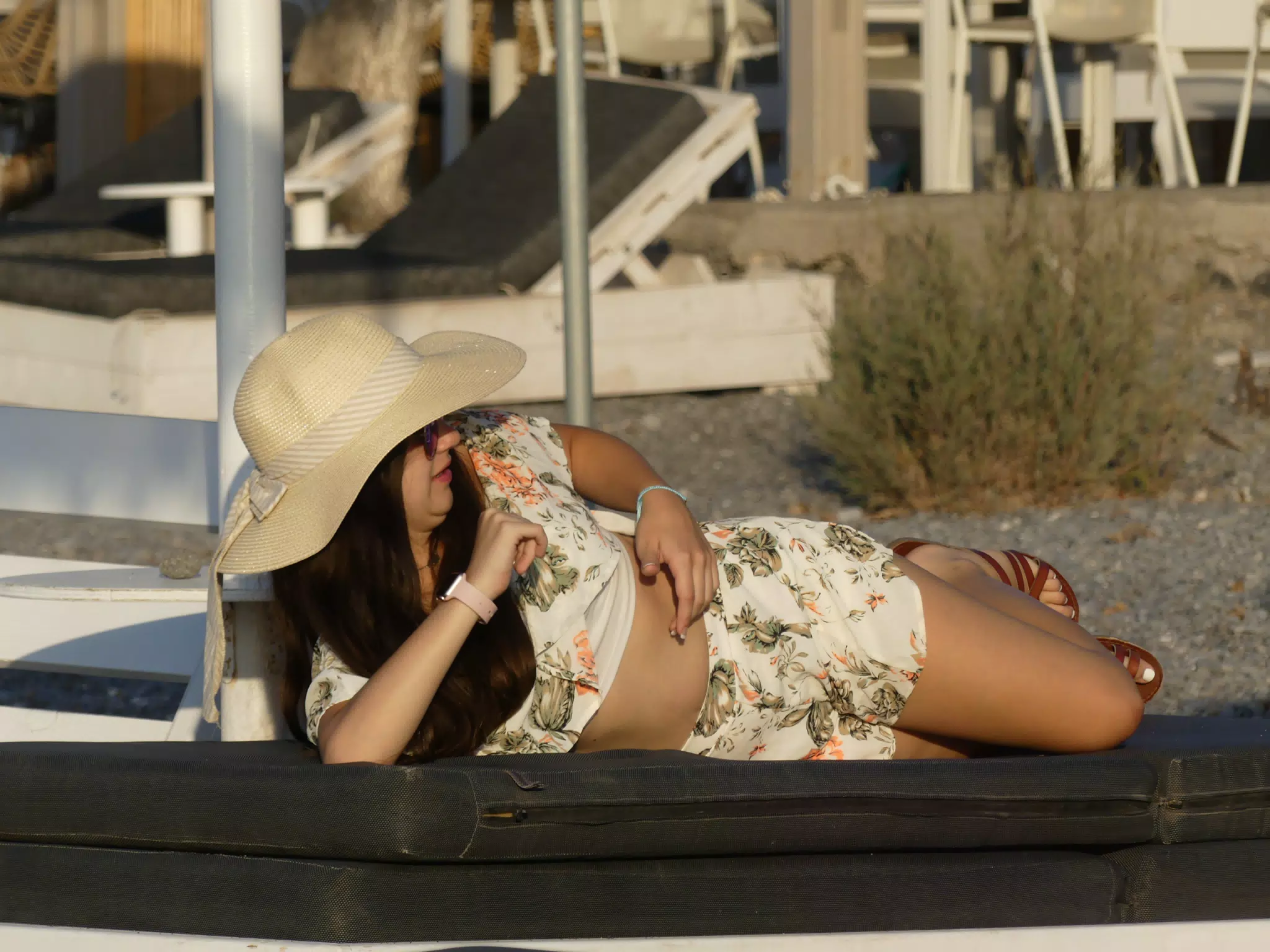 Girl Turning Over on Lounge Chair on Beach