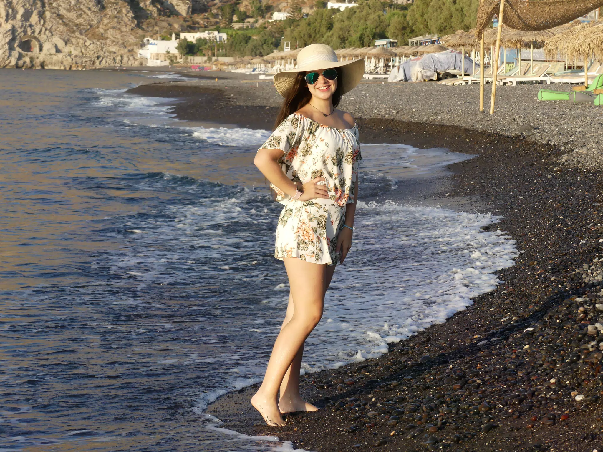Emily with Hat and Sunglasses on Kamari Beach on Santorini