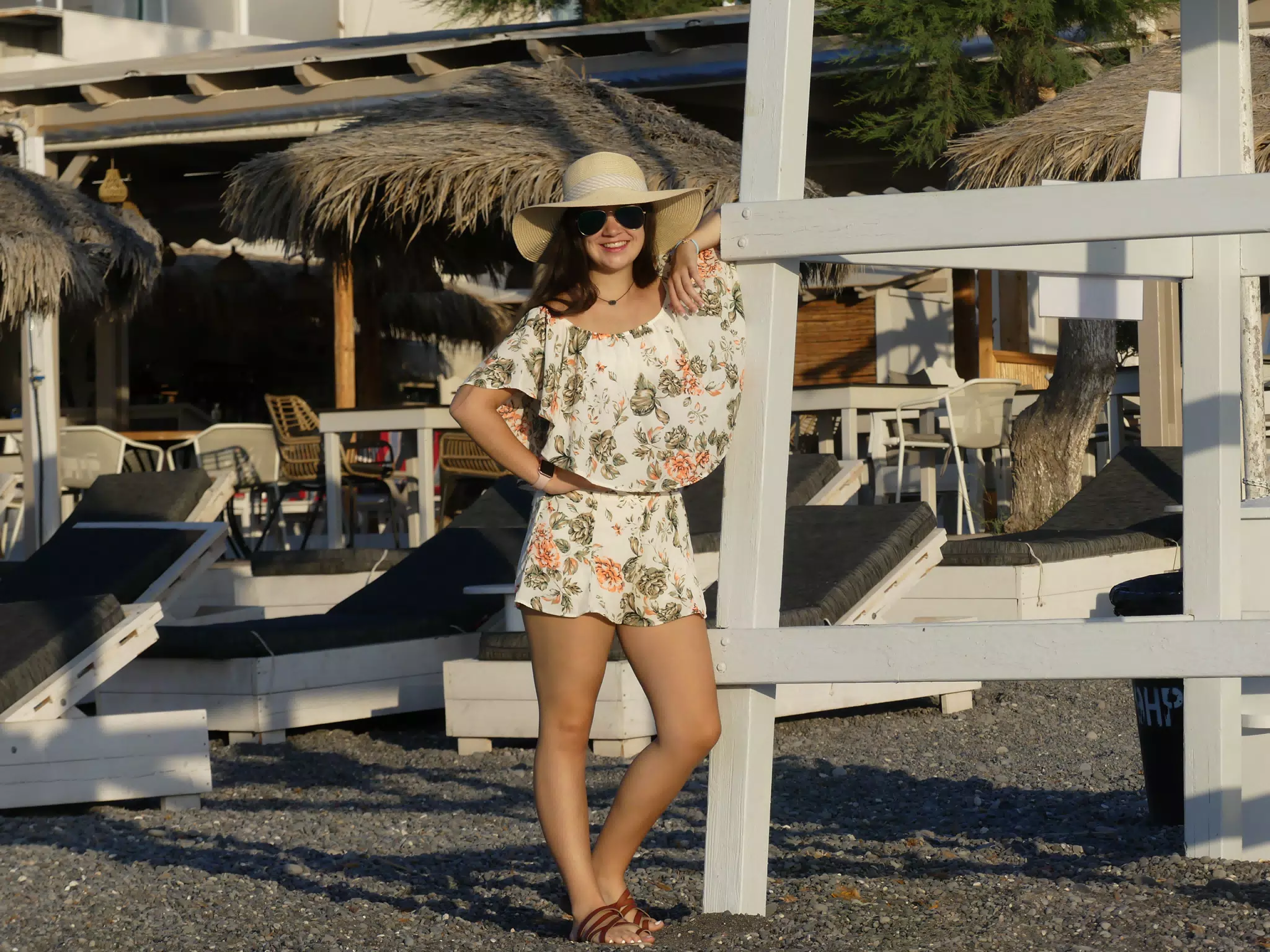 Emily Leaning on Lifeguard Tower on Santorini Beach