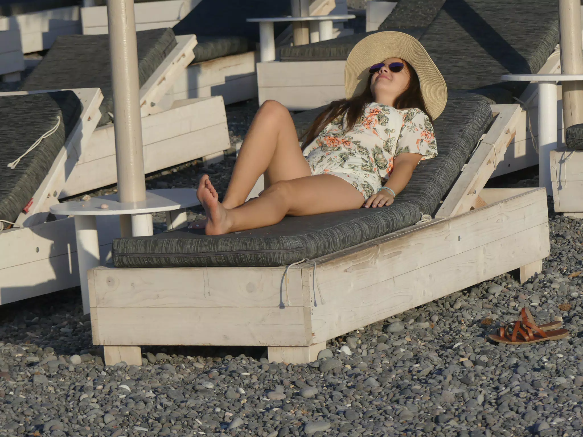Girl Laying on Lounge Chair on Kamari Beach on Santorini