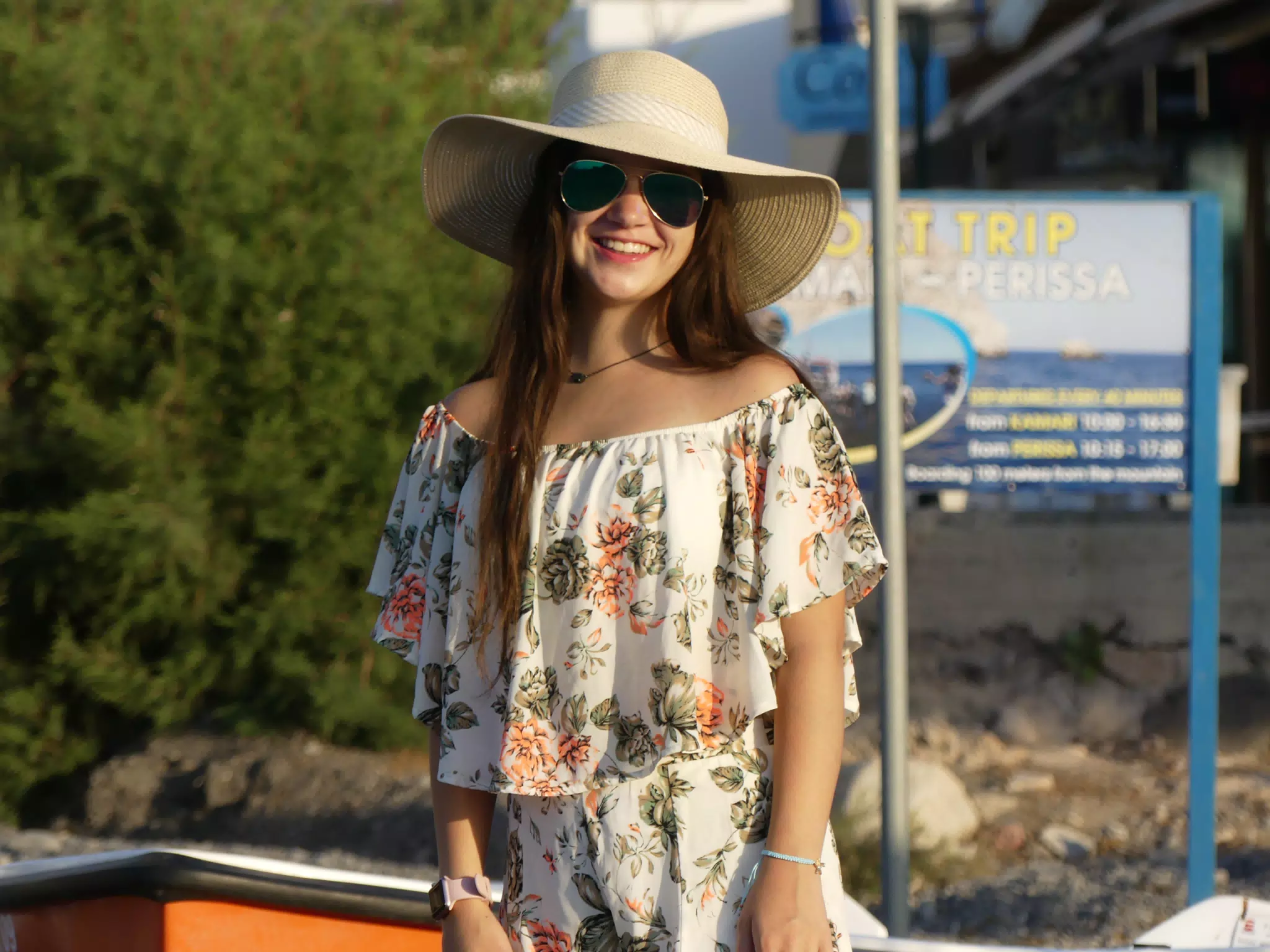 Girl in Hat Standing on Santorini Beach at Kamari