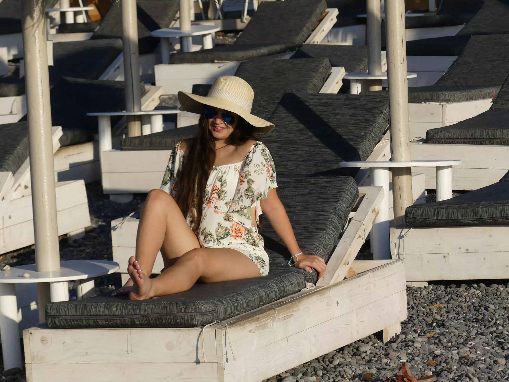 Girl Lounging with Hat on Santorini Beach