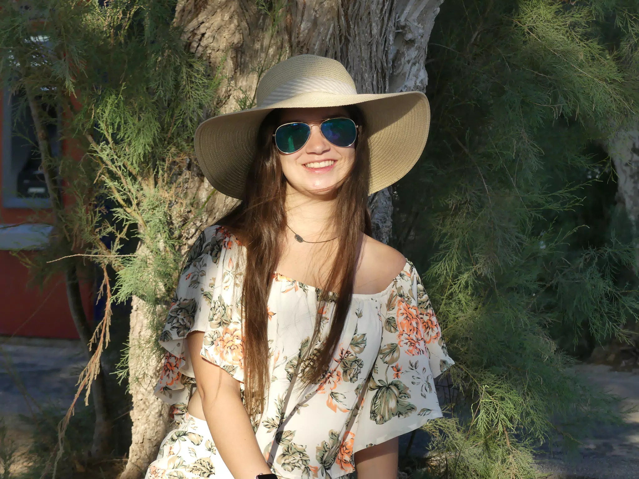Emily in Hat in Front of Tree on Santorini