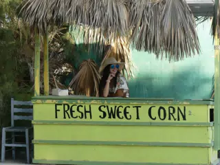 Girl in Hat Selling Corn
