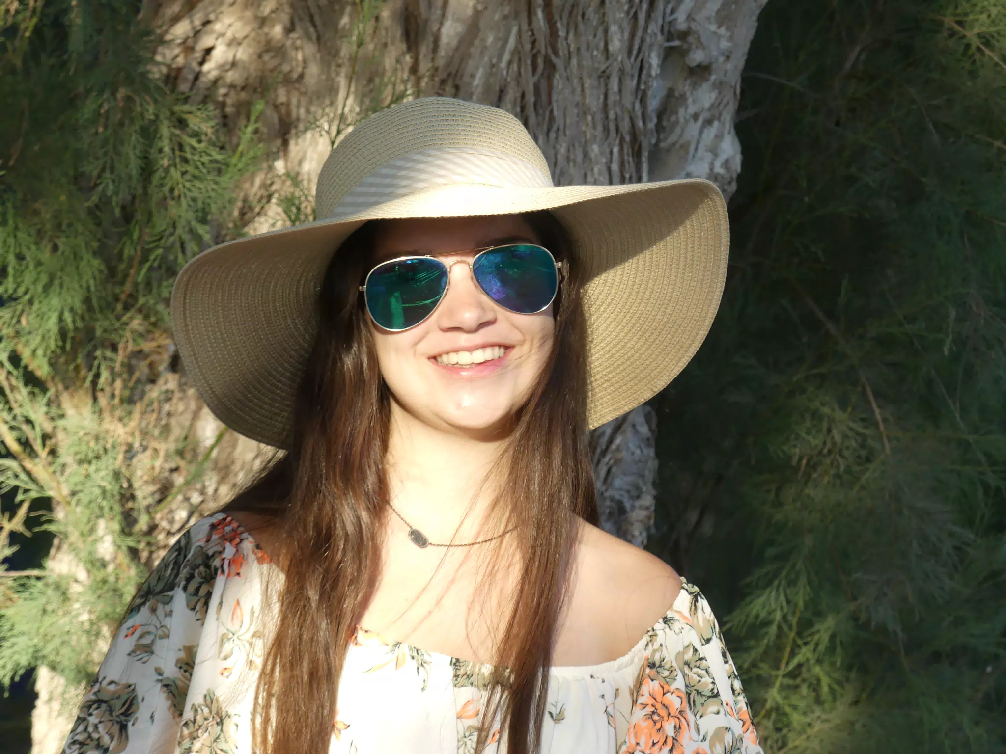 Emily in Hat by Tree at Kamari Beach