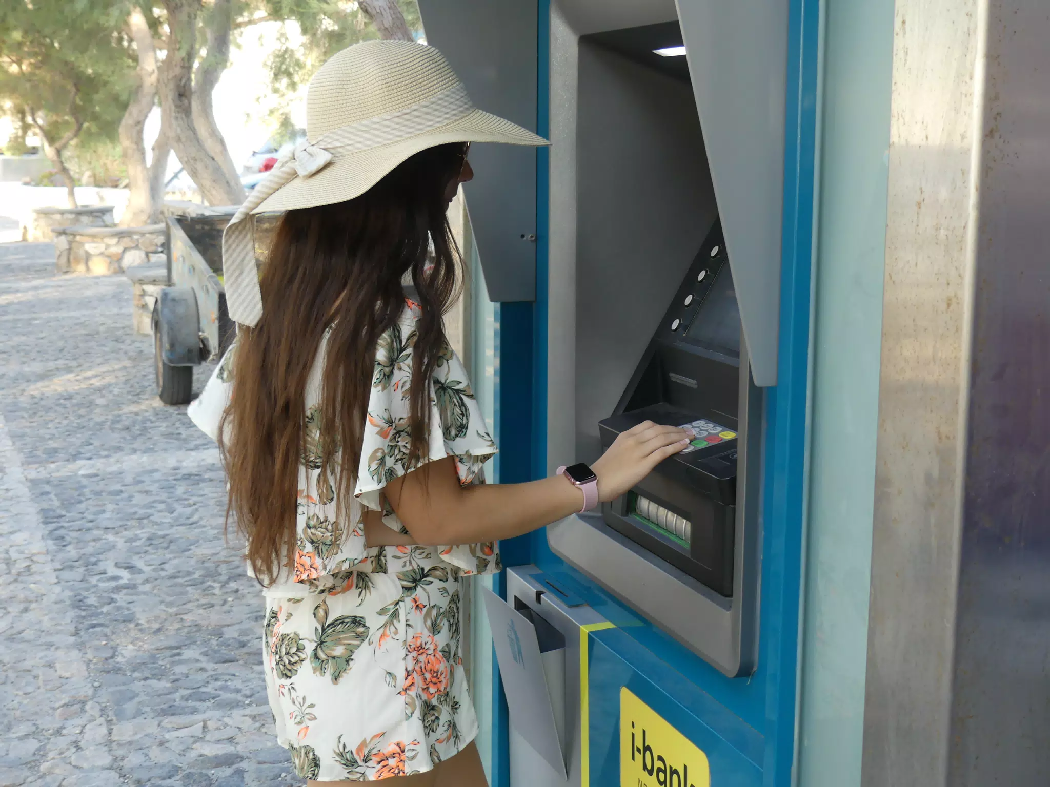 Teen Using ATM in Greece