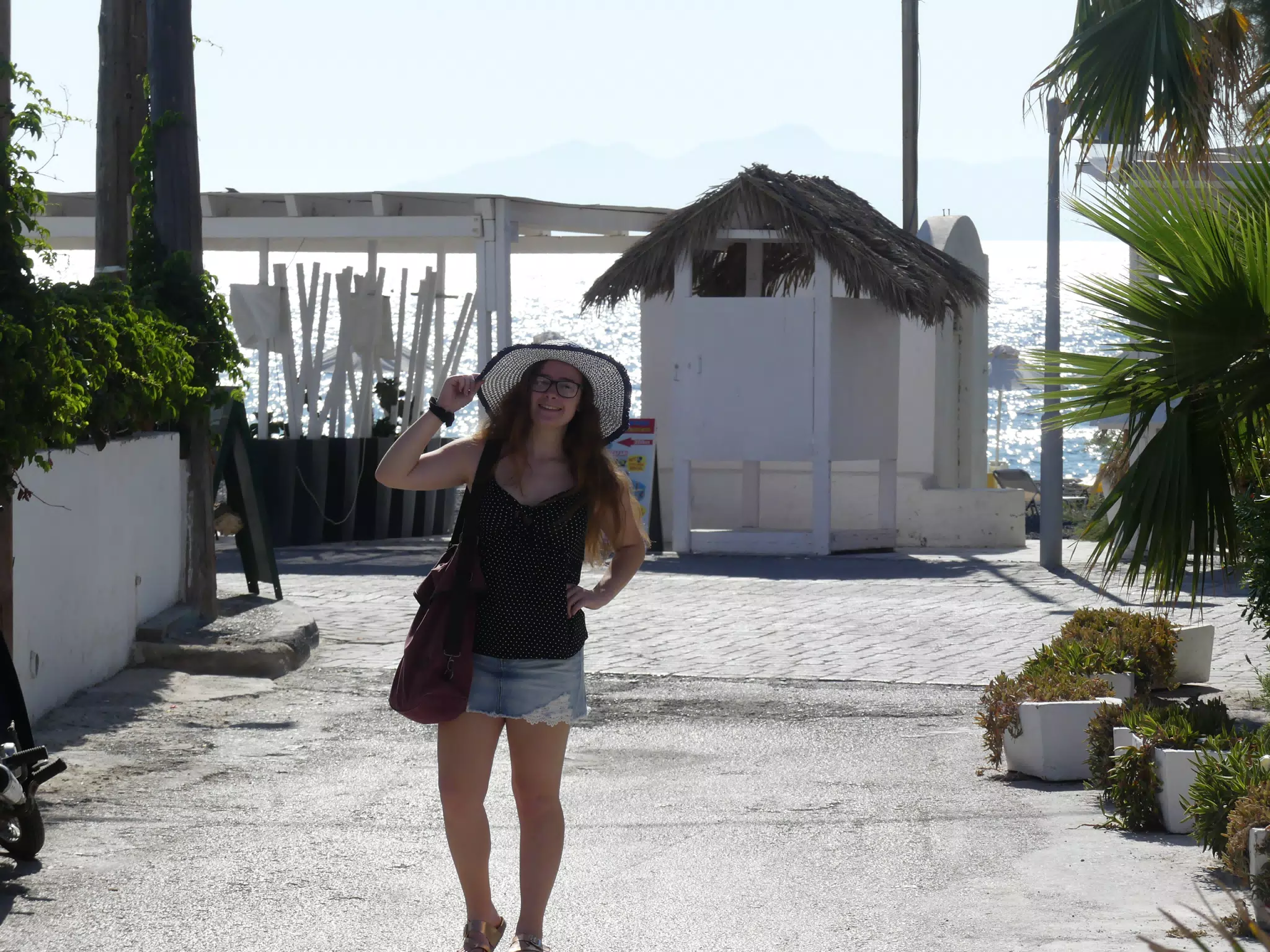 Girl in Skirt with Hat at Kamari Beach Road on Santorini