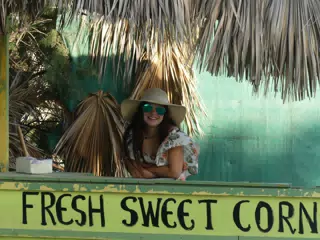 Teen Girl Selling Fresh Sweet Corn on Santorini