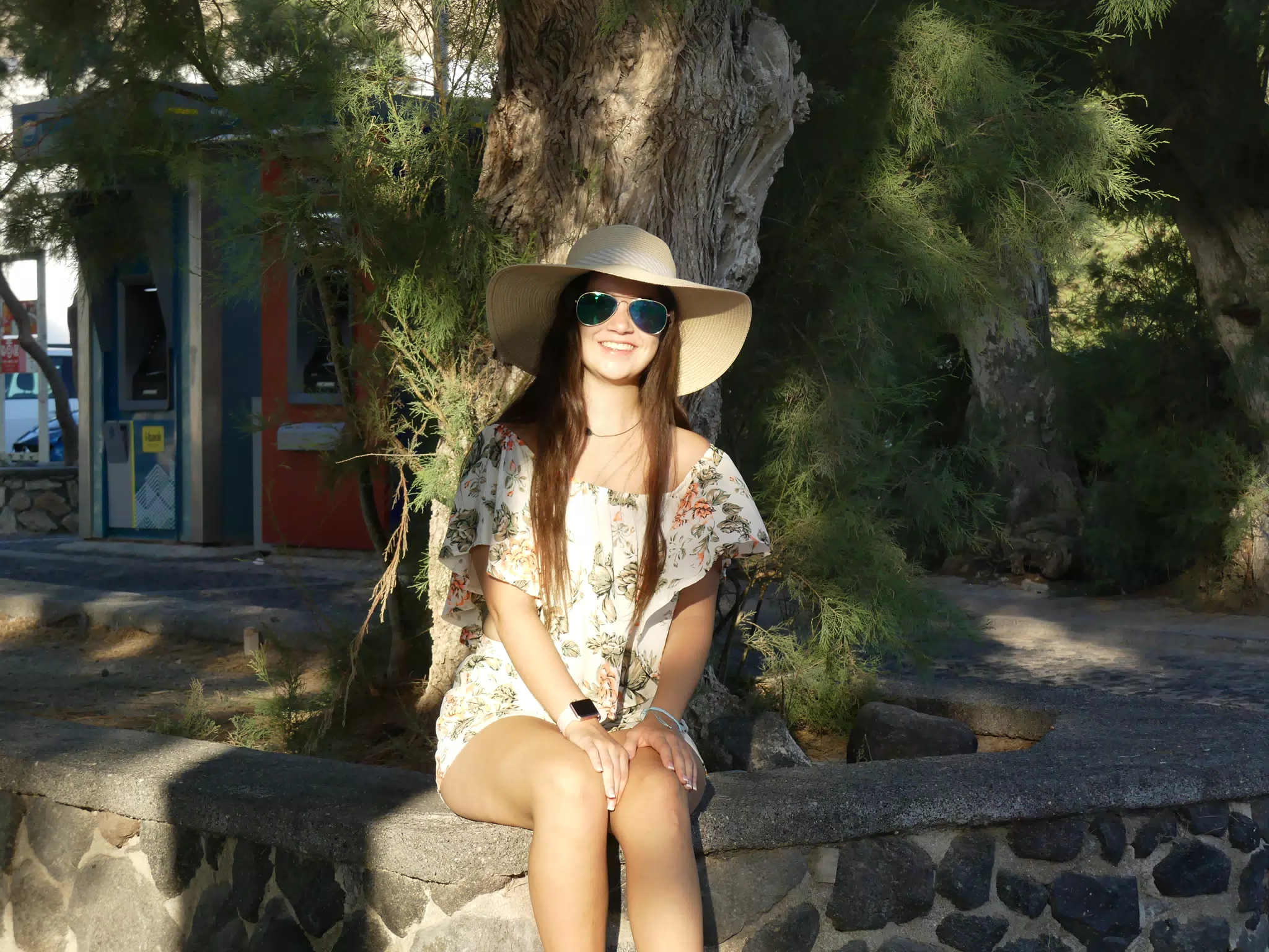 Emily Sitting on Birm Around Tree on Santorini