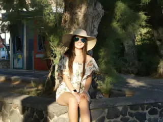 Emily Sitting on Birm Around Tree on Santorini