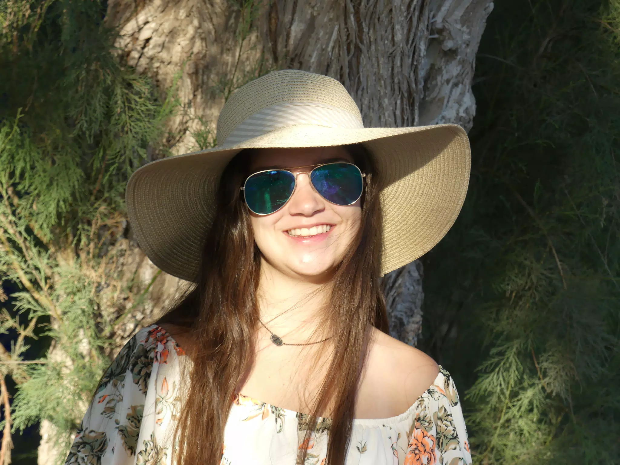 Emily in Hat by Tree at Kamari Beach