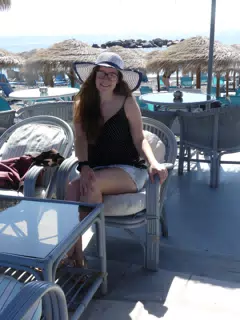 Madeline on Beach on Santorini in Hat and Skirt